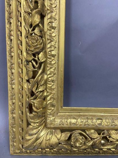 Carved and gilded wood frame with openwork...