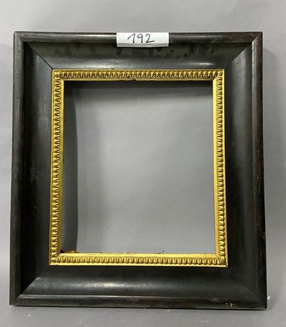 Blackened and moulded wooden frame with gold...