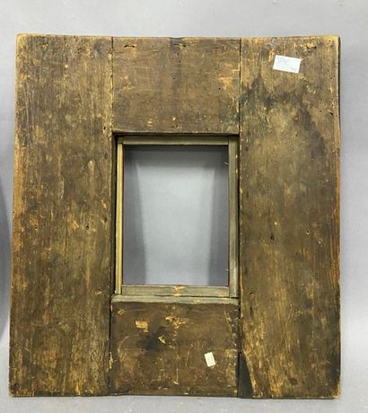 Blackened moulded wooden frame with an upside-down...