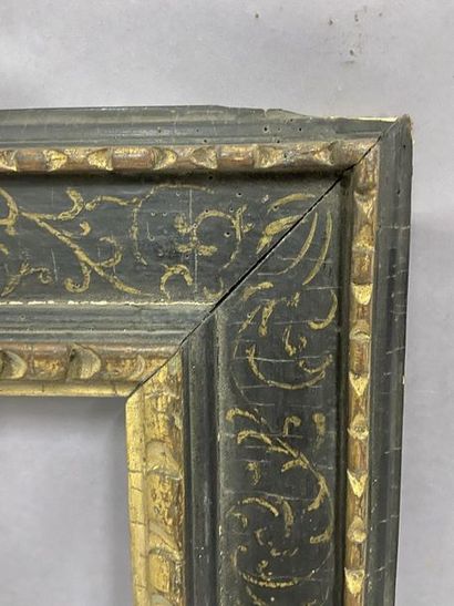 Carved and gilded wood frame with a black...