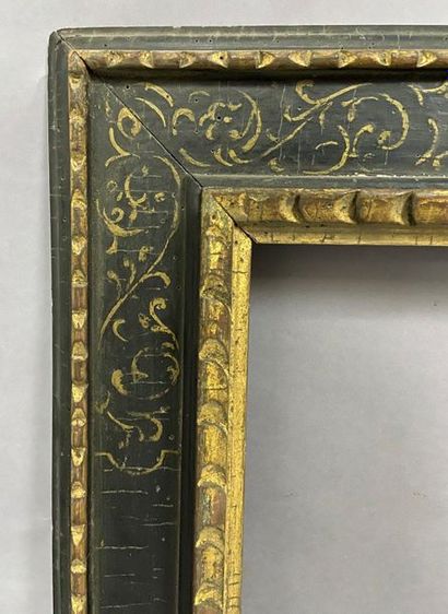 Carved and gilded wood frame with a black...