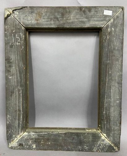 Carved and gilded wood frame with a black...