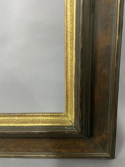 Moulded wooden frame with a patina and gilded...