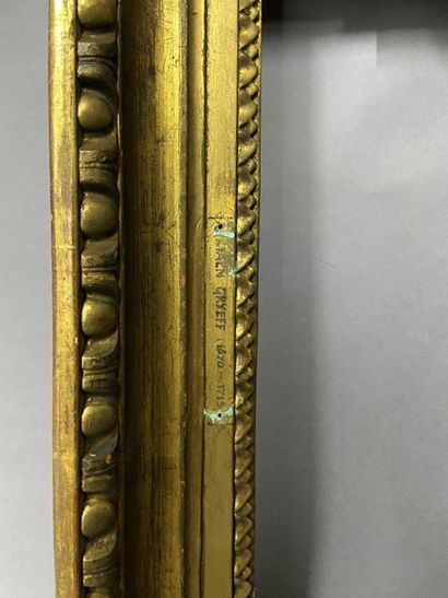 Carved and gilded wood frame with a frieze...
