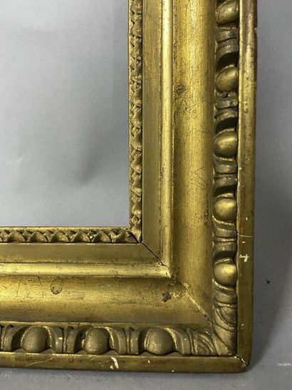 Carved and gilded wood frame with a frieze...