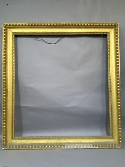Carved and gilded wooden frame with a frieze...