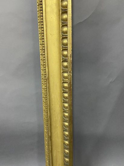 Carved and gilded wooden frame with a frieze...
