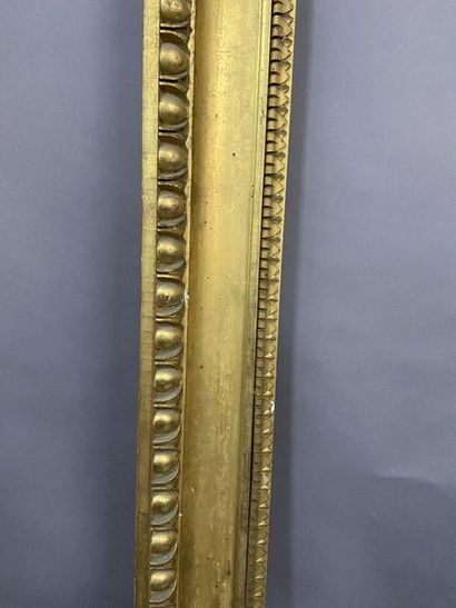 Carved and gilded wooden frame with a frieze...