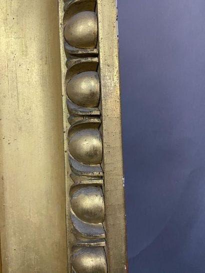 Carved and gilded wooden frame with a frieze...