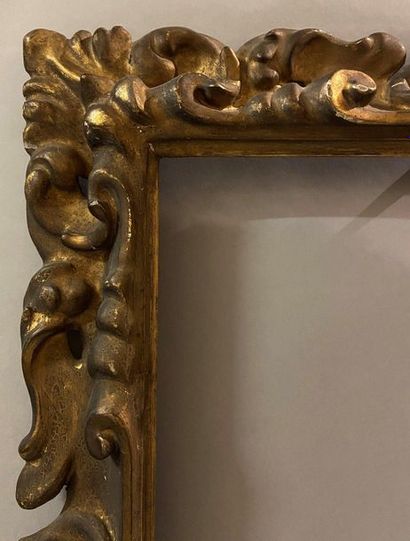 Carved and gilded wooden frame with openwork...