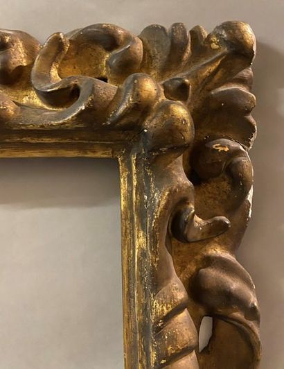 Carved and gilded wooden frame with openwork...