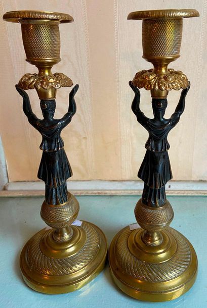 Paire de bougeoirs en bronze doré et patiné...