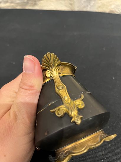 Black stone inkwell with ormolu frame, incised...