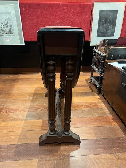 Turned wood cabinet legs and metal braces....