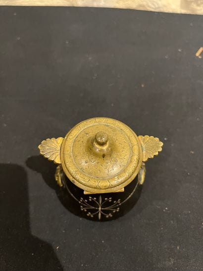 Black stone inkwell with ormolu frame, incised...