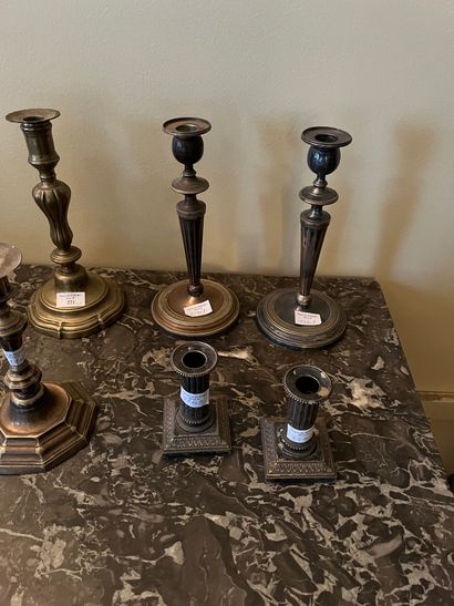 Nine metal torches, including silver-plated...