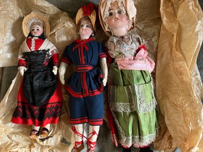 Three regional dolls, porcelain heads, one...