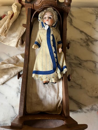 Set of doll clothes in wooden trunk, two...