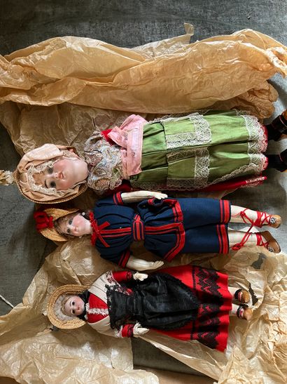 Three regional dolls, porcelain heads, one...