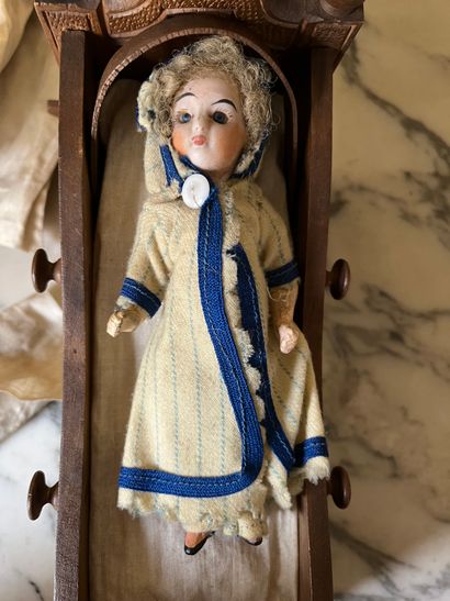 Set of doll clothes in wooden trunk, two...