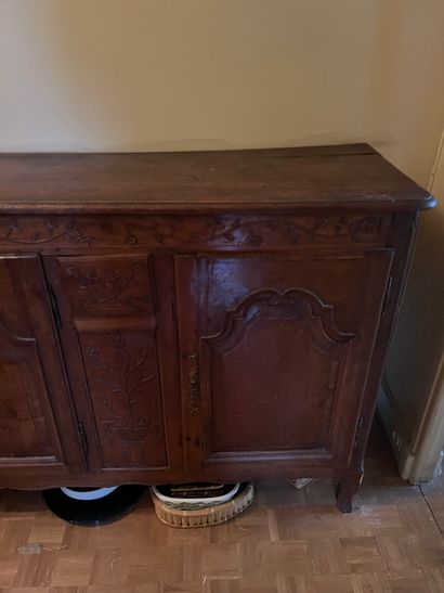 Carved fruitwood sideboard with three leaves...