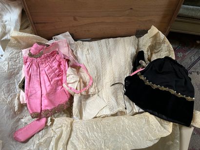 Set of doll clothes in wooden trunk, two...
