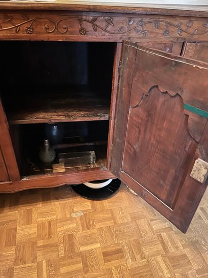 Carved fruitwood sideboard with three leaves...