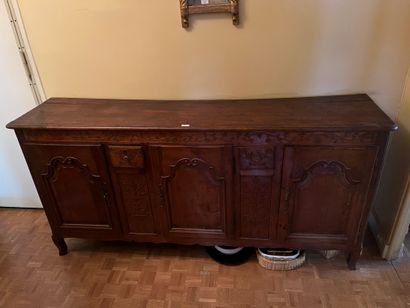 Carved fruitwood sideboard with three leaves...