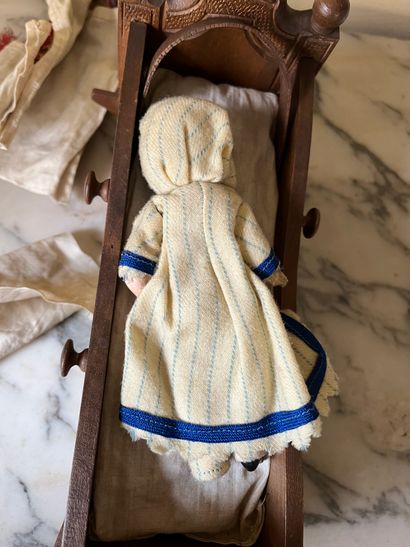 Set of doll clothes in wooden trunk, two...