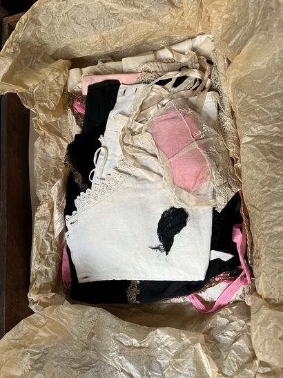 Set of doll clothes in wooden trunk, two...