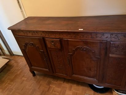 Carved fruitwood sideboard with three leaves...
