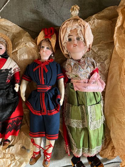 Three regional dolls, porcelain heads, one...