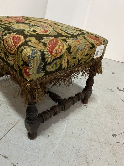 Turned wood stool joined by a spacer.
Upholstered...