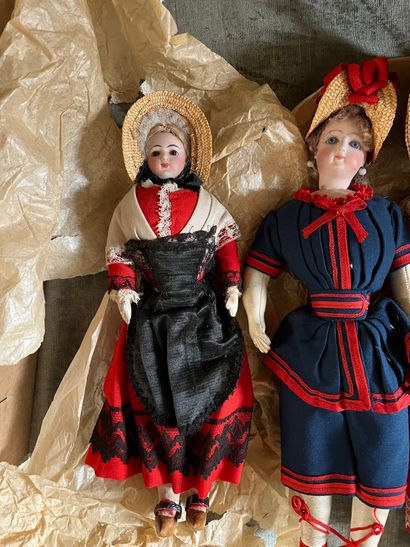 Three regional dolls, porcelain heads, one...