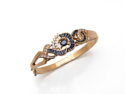750 thousandths gold openwork bangle decorated...