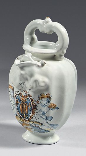 FAENZA
Ribbed earthenware ewer, with scroll-shaped...