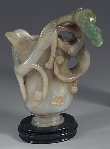 CHINA
Apple-green jadeite rhyton carved in...