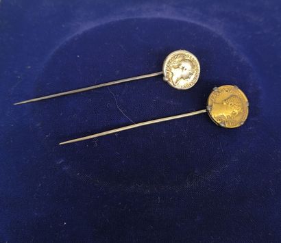 Two metal pins decorated with coins in the...