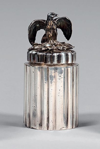 Cylindrical box with silvery metal ribs,...