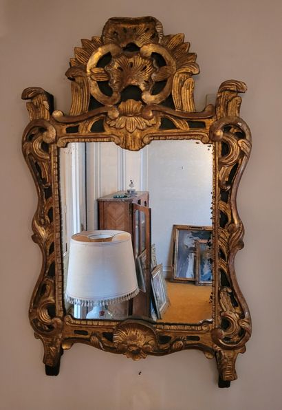 MIRROR in a gilded wood frame carved with...