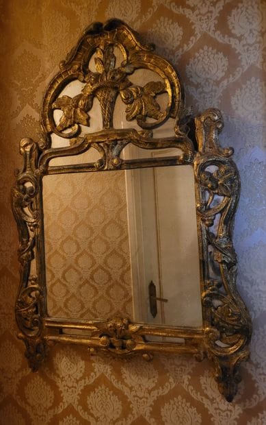 MIRROR in a gilded wood frame carved with...