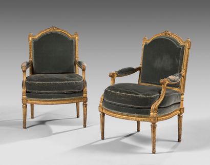 Pair of curved flat-back armchairs in gilded...