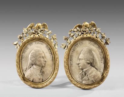 Pair of oval terra cotta medallions with...
