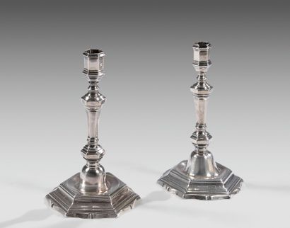 Two silver candlesticks forming a pair with...