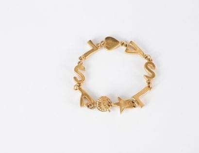 YVES SAINT LAURENT.

Bracelet en métal doré...
