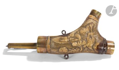 An antler powder flask carved with an extended...