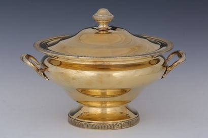 A vermilion-colored metal soup tureen with...