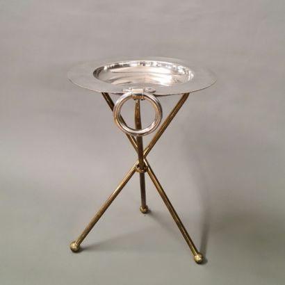 A 1960's era end table with a round silver...