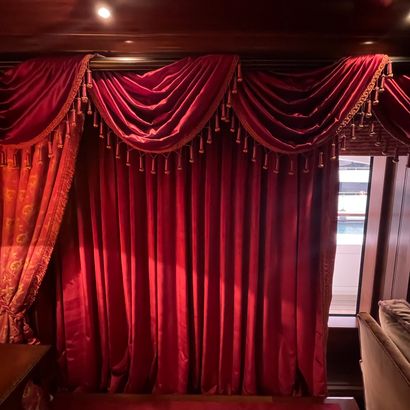 PAIR OF CURTAINS in red velvet, the edge...