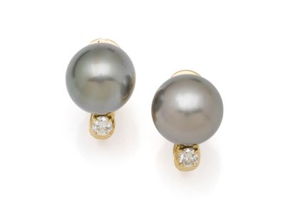 PAIR OF EAR CLIPS topped with a brilliant-cut...